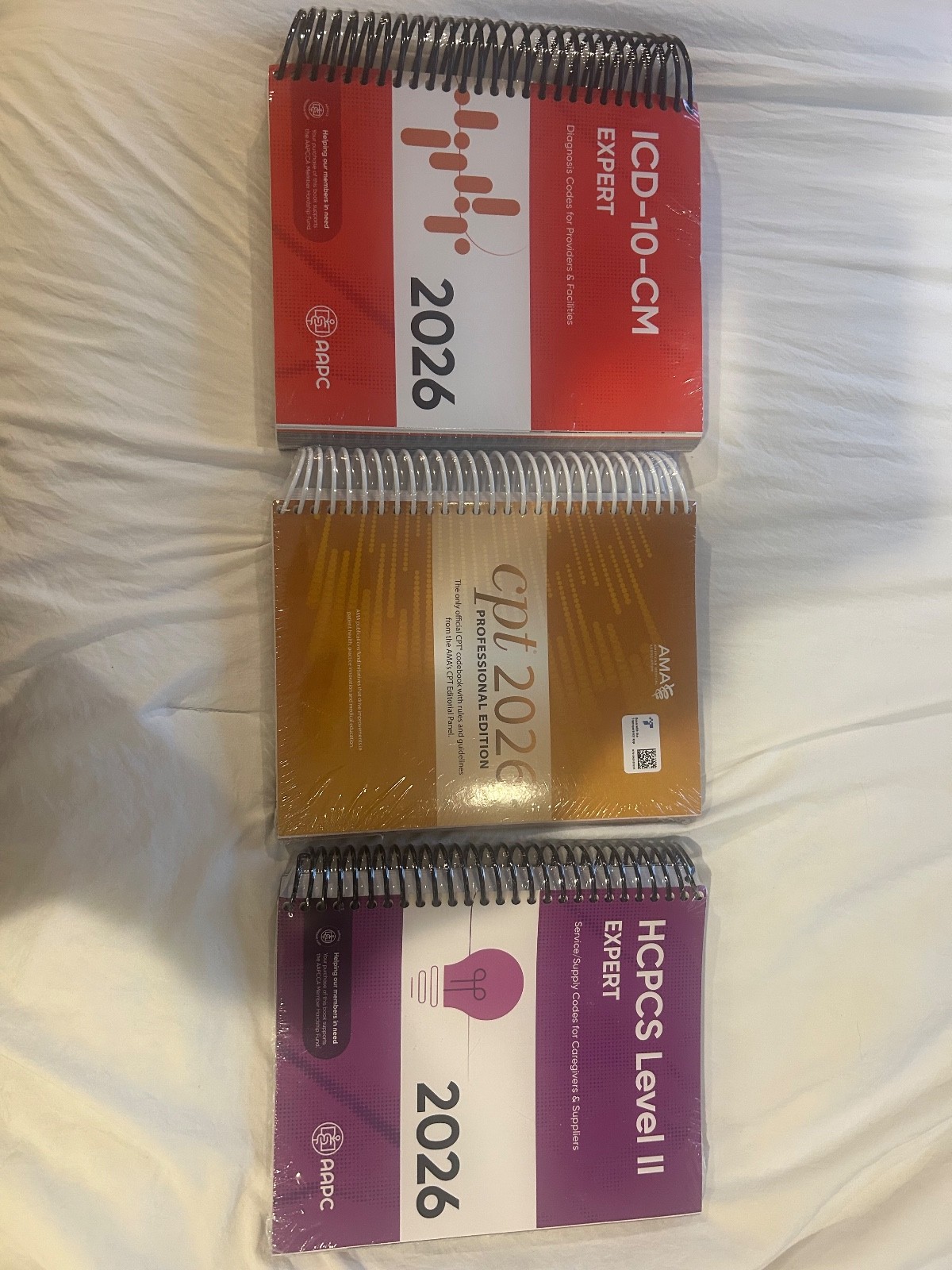AMA CPT Book, ICD-10 Code Book, HCPCS Book – 2026 Physician Bundle by AAPC NEW